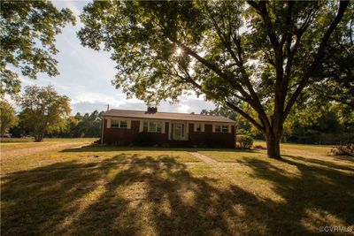 Ranch-style house with a front lawn | Image 1