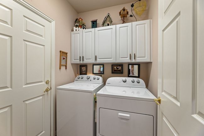 Laundry area featuring independent washer and dryer and cabinet space | Image 30