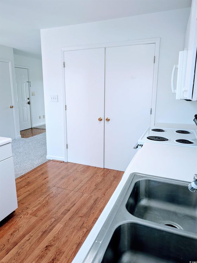 Washroom featuring light wood-style floors and a sink | Image 6