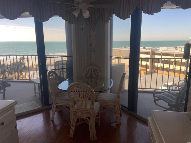 Dining room with hardwood / wood-style floors, a beach view, a water view, and ceiling fan | Image 13