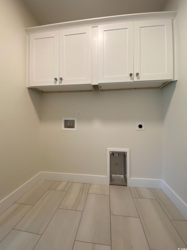 Laundry area with electric dryer hookup, cabinet space, and washer hookup | Image 31