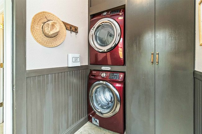 Clothes washing area featuring laundry area, stacked washer and clothes dryer, and wainscoting | Image 18