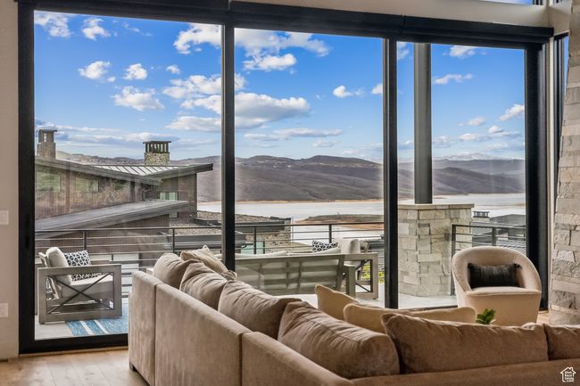 Interior space featuring a water and mountain view and wood finished floors | Image 17