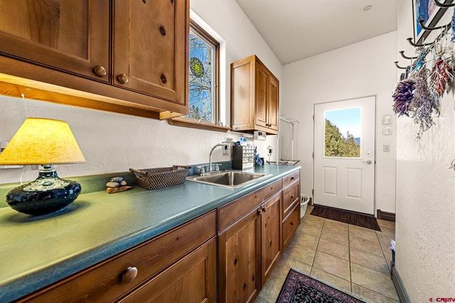 Plenty of storage and counterspace in the laundry room | Image 31