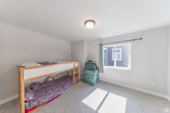 Carpeted bedroom with carpet, large windows and a walk in closet. | Image 18