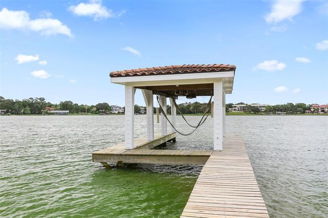 This boathouse is 10' W X 30' L and offers a 6000 LB lift with straps. | Image 47