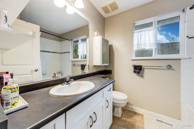 Full bathroom featuring tile patterned floors, visible vents, toilet, and vanity | Image 27