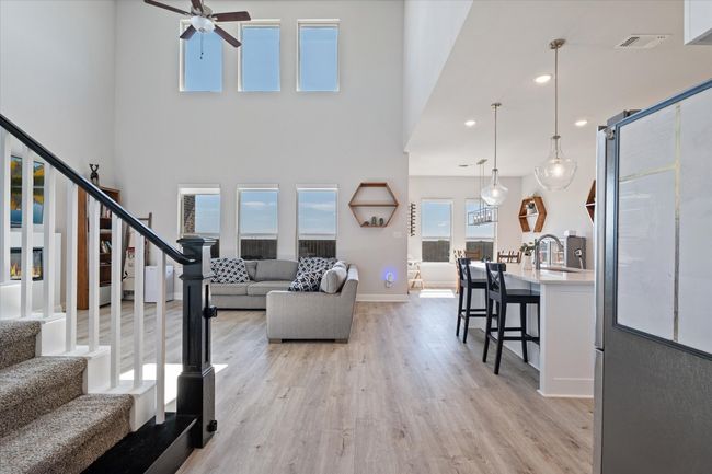 Living room featuring a ceiling fan, light wood-style flooring, stairway, recessed lighting, and baseboards | Image 6