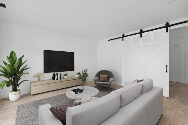 Living area featuring wood finished floors, recessed lighting, and a barn door | Image 17