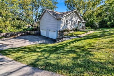 View of side of property featuring a garage and a yard | Image 2