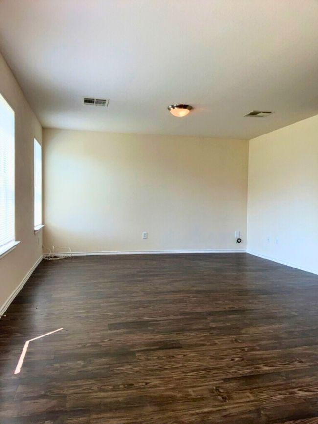 Living room with dark wood-style flooring and baseboards | Image 9