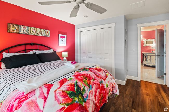 Bedroom featuring ceiling fan, a closet, and dark wood-type flooring | Image 64