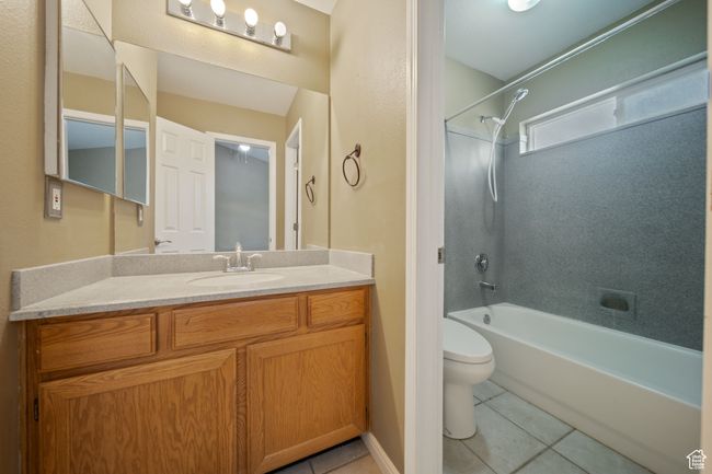 Bathroom featuring tile patterned floors, shower / tub combination, and vanity | Image 21
