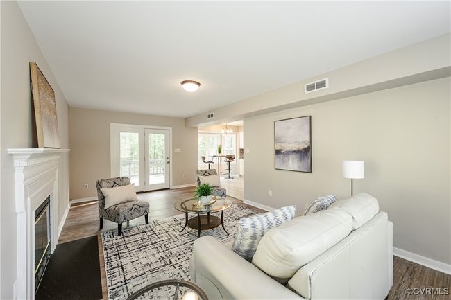 Living room featuring baseboards, visible vents, and dark wood-style floors | Image 25