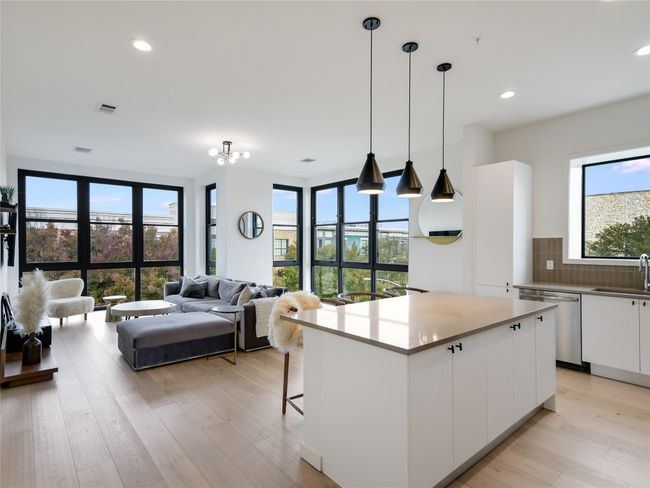 Kitchen with modern cabinets, a sink, backsplash, stainless steel dishwasher, and a center island | Image 8