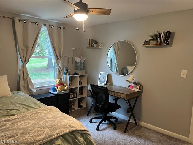 Bedroom with dark colored carpet and ceiling fan | Image 16