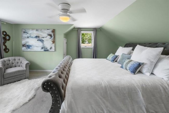 2nd floor Bedroom featuring ceiling fan, carpet floors, and lofted ceiling | Image 15