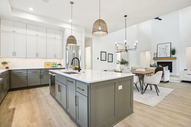A chef’s dream kitchen, equipped with a massive island, double ovens, and custom cabinetry. | Image 17