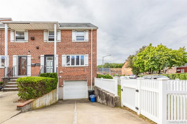 View of front facade featuring brick siding, concrete driveway, and an attached garage | Image 22