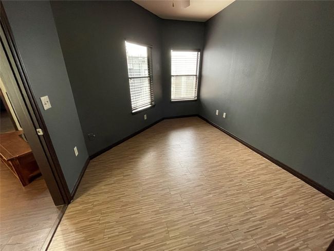 Empty room featuring light wood-type flooring, baseboards, and ceiling fan | Image 15