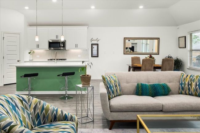 Living room with vaulted ceiling, recessed lighting, wood finished floors, and baseboards | Image 11