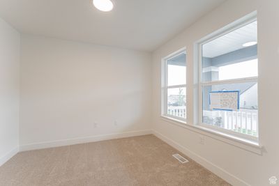 Carpeted empty room featuring plenty of natural light | Image 2