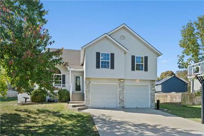 View of front facade featuring a front yard and a garage | Image 3