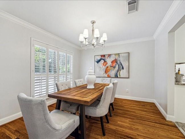 Large formal dining room with plenty of light. | Image 6