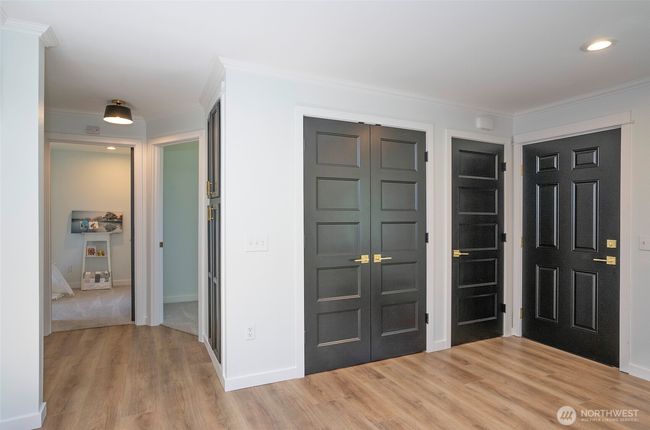 Behind the double doors, the space is made perfectly for your stackable washer and dryer. | Image 19