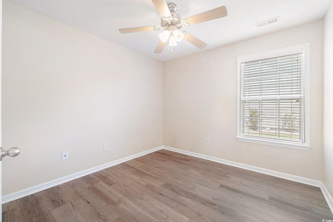 Spare room with wood finished floors, a ceiling fan, and a textured ceiling | Image 28