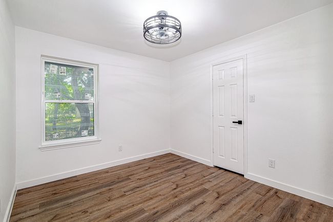 Spare room with wood finished floors and baseboards | Image 28