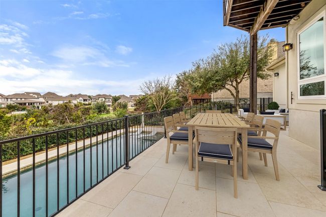 Balcony with outdoor dining area, a residential view, and view of pool area | Image 6