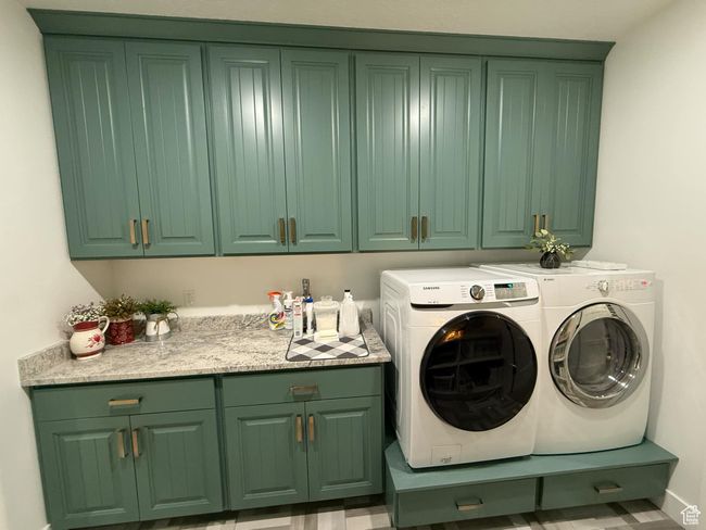 Laundry room featuring cabinet space and washer and dryer | Image 47