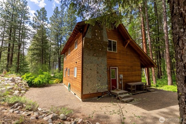 Climbing wall located on the private, forested side of the house for shade, privacy, and a true outdoor recreation vibe. An ideal feature for families, training, or fun weekend challenges—rarely found in residential properties. | Image 37