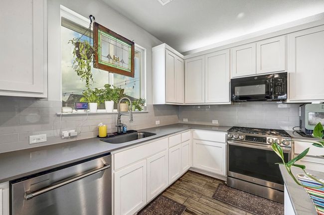 Sleek stainless steel dishwasher and range. | Image 10