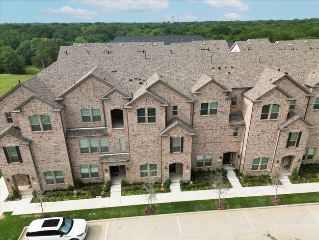 View of front facade with uncovered parking and brick siding | Image 15