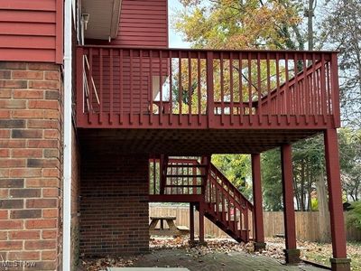 View of wooden deck with patio below | Image 2