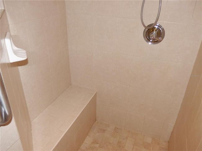 walk-in shower all tield up to ceiling and bench | Image 43