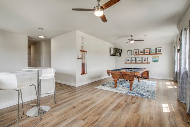Game room with ceiling fan, pool table, and light wood finished floors | Image 25