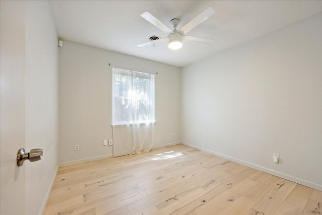 Empty room with visible vents, baseboards, ceiling fan, and hardwood / wood-style floors | Image 20