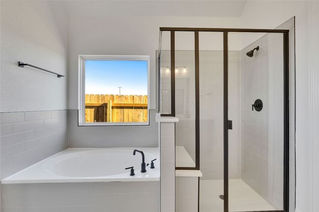 Bathroom featuring a garden tub and a stall shower | Image 8