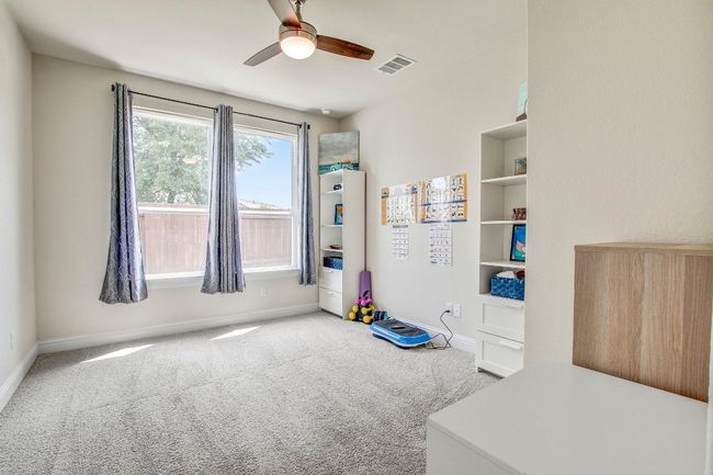Bedroom with carpet floors and a ceiling fan | Image 21
