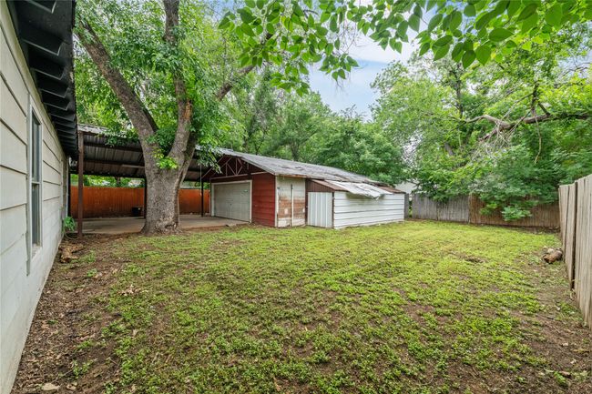 View of yard featuring an outbuilding and a detached garage | Image 22