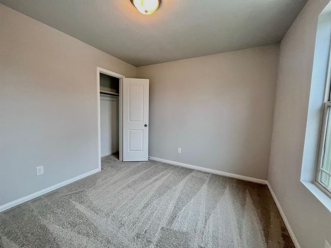 Experience the comfort of this virtually staged bedroom featuring plush carpeting. | Image 29