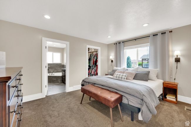 Carpeted bedroom featuring a spacious closet, a closet, recessed lighting, and ensuite bathroom | Image 9
