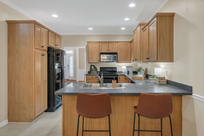 WARMTH + FUNCTIONALITY A Combination of Upgraded Cabinetry w/ Built In Appliances + Large Pantry | Image 20
