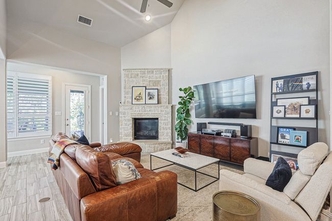 Family room is large enough to afford different decorating styles. The fireplace offers extra cozy feel for the coming cool nights. | Image 13