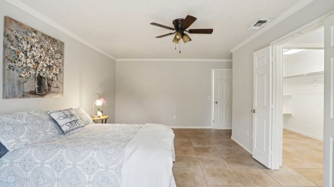 Bedroom with ornamental molding, visible vents, and light tile patterned floors | Image 20