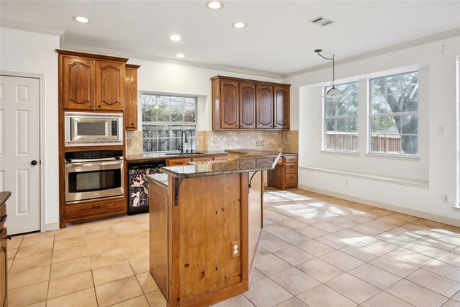 Great view of kitchen and breakfast room overlooking backyard. | Image 20