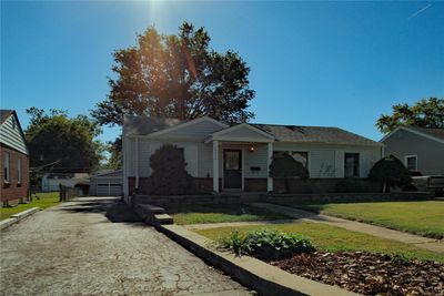 View of front of home with a front yard, a garage, and an outbuilding | Image 2